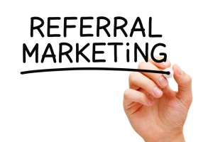 Hand writing Referral Marketing with black marker on transparent wipe board.